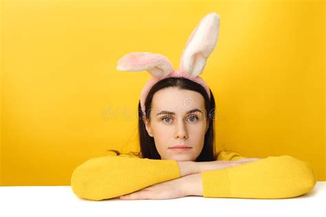Image of Lovely Female Leans on White Table, Wears Fluffy Ears, Dressed in Sweater, Models Over ...
