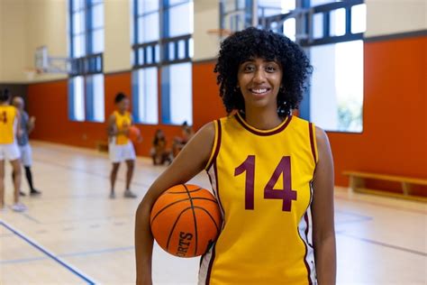 Premium Photo | Portrait of happy biracial female basketball players ...