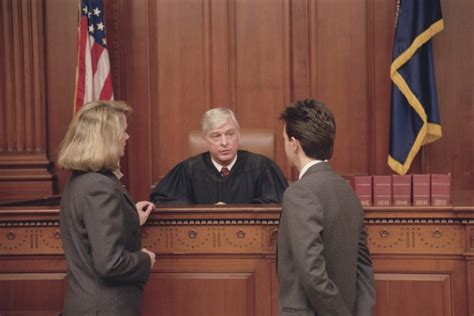 Judge and lawyers in courtroom - Judge Brian MacKenzie