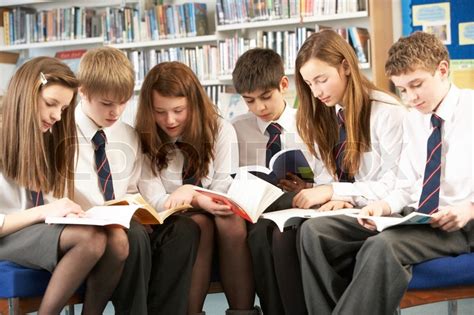 Teenage Students In Library Reading Books | Stock Photo | Colourbox