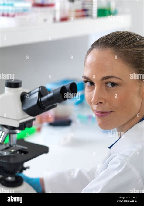 Portrait of female scientist by a microscope Stock Photo - Alamy