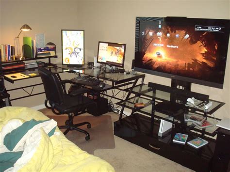 a living room filled with furniture and a flat screen tv on top of a desk