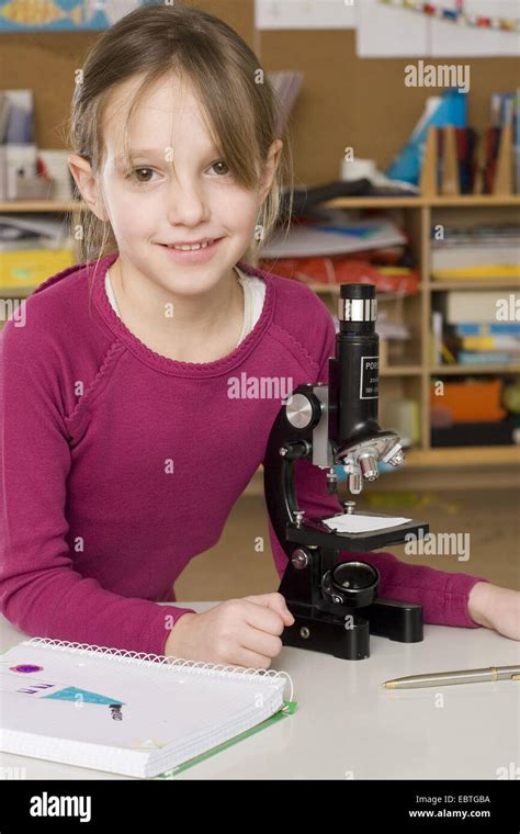 schoolmate learning with a microscope Stock Photo - Alamy