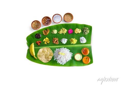 Traditional food onam sadya served on a banana leaf on festival posters ...