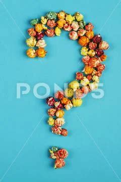 Photograph: Question mark laid out from corn kernels on a blue background. #130210552