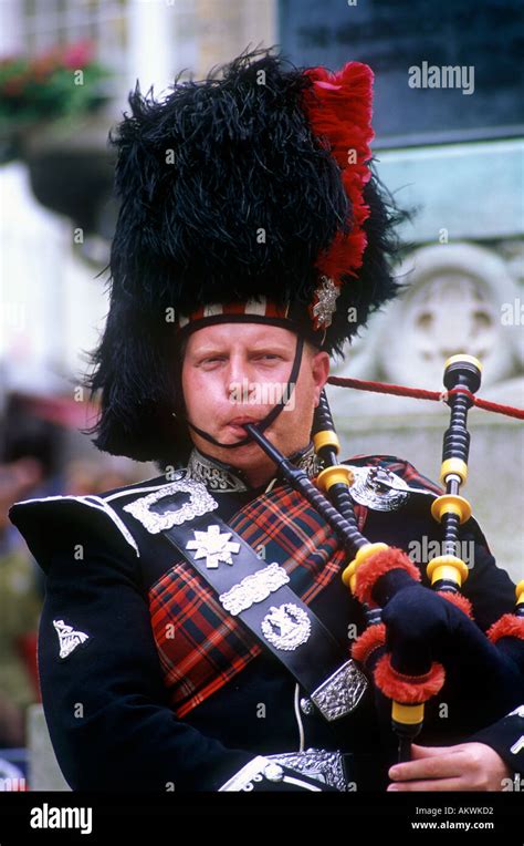 scottish man in traditional army uniform playing bagpipes Stock Photo ...