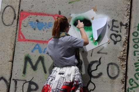 Painting graffiti on the Apartheid Wall | The Apartheid Wall… | Flickr