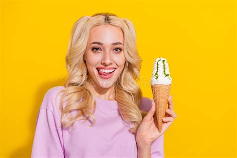 Portrait of Cheerful Cute Girl Tongue Lick Teeth Hold Ice Cream Look Camera Isolated on Yellow ...