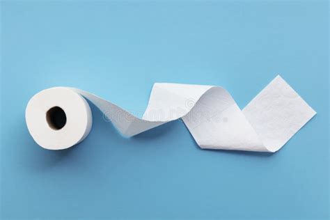 A Single Roll of Toilet Paper Unrolled on a Blue Background Stock Image ...