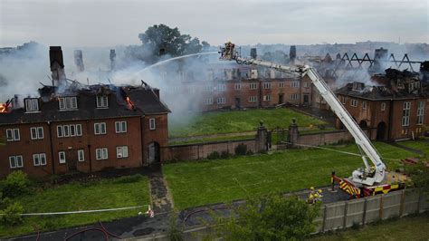 Huge fire destroys part of listed building - man arrested | UK News | Sky News