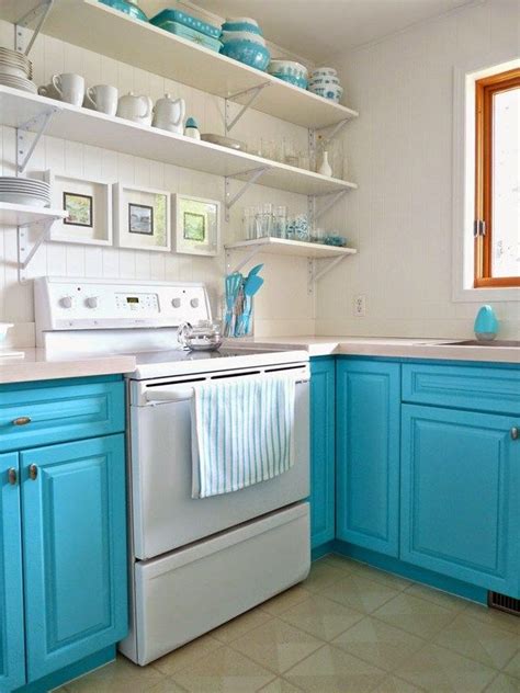 a kitchen with blue cabinets and white appliances