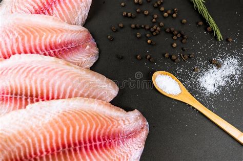 Fresh Fillet of White Tilapia Fish Laid Out Against a Black Background. Stock Image - Image of ...