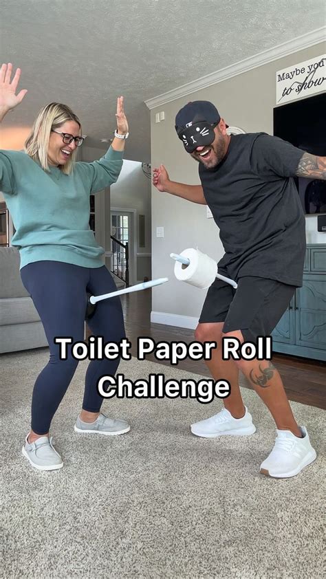 two people in a living room with the text toilet paper roll challenge