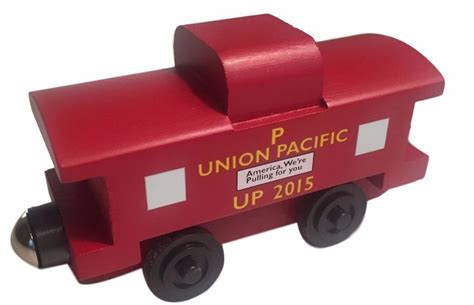 a red wooden toy train with the union pacific logo on it's front wheel