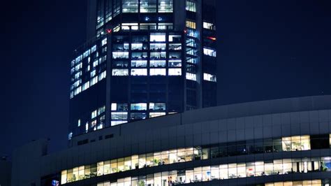 Premium Photo | Fragment of the glass facade of a modern corporate building at night