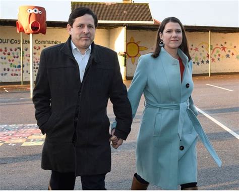 Jo Swinson looks nervous as she arrives to vote hand in hand with her ...