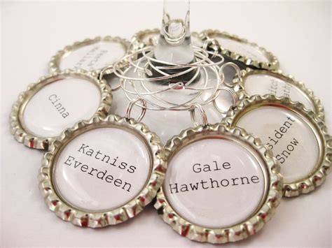 Hand Made Upcycled Bottle Caps Hunger Games Wine Charms In Set Of 8 by Glassology | CustomMade.com
