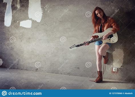 Young Red-haired Girl with an Electric Guitar. Rock Musician Gir Stock ...