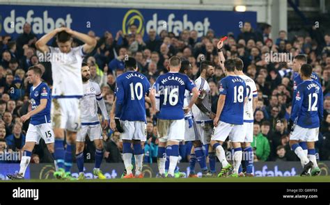 Chelsea's Diego Costa is shown the red card by referee Michael Oliver ...