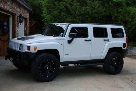 a white jeep parked in front of a brick building