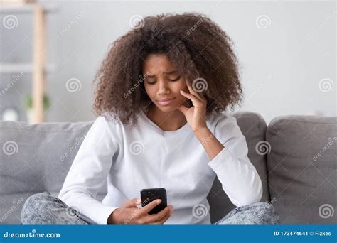 Upset Depressed African Teen Girl Looking at Phone at Home Stock Image - Image of person ...