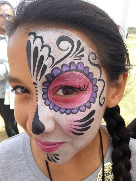 Simple and pretty half day of the dead/sugar skull face painting makeup by Cynnamon painted at ...