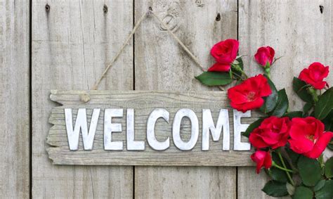 Rustic Welcome Sign with Red Flowers Hanging on Wood Door Stock Image - Image of green, country ...