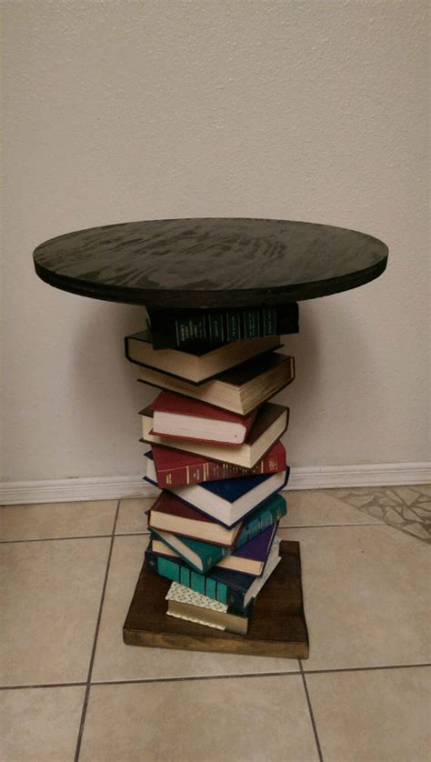 a stack of books sitting on top of a wooden table