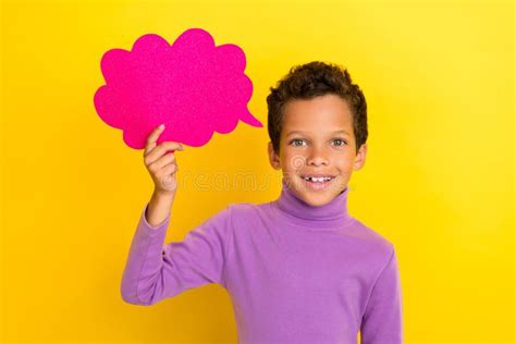 Photo of Positive Boy Hand Hold Empty Space Paper Cloud Shape Card on Yellow Color Background ...