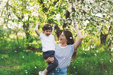 Happy mother's day. Mother with little baby son in spring garden during ...