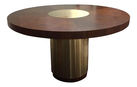 a round wooden table with a metal base