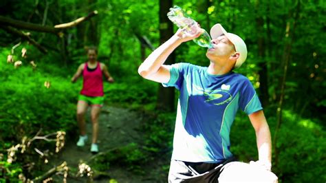 Man drinking water after jogging, steadycam shot, slow motion shot at ...