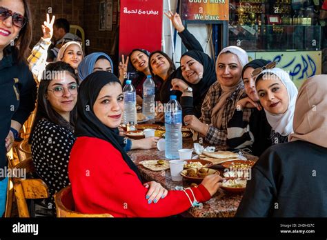 A Group Of Young Jordanian Women Enjoy Breakfast Outside A Cafe In ...