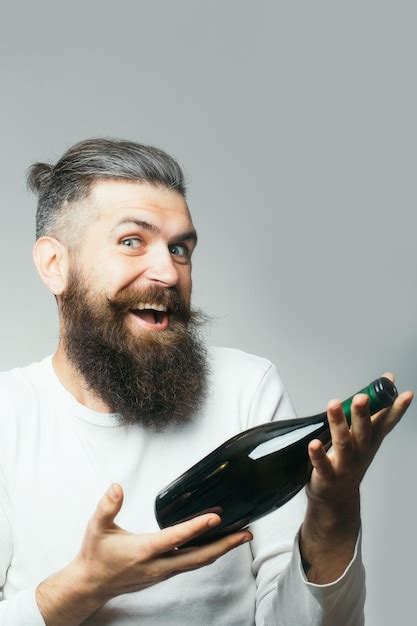 Premium Photo | Bearded man with wine bottle