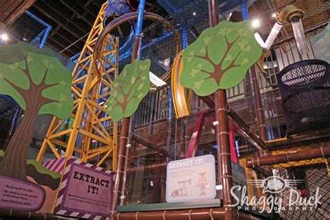 the inside of an indoor play area with trees and other things on ...