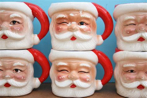 six santa claus mugs sitting next to each other