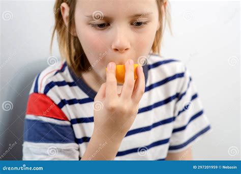 Fruity Munch: a Young Boy Munches on a Ripe Yellow Plum, Enjoying the ...