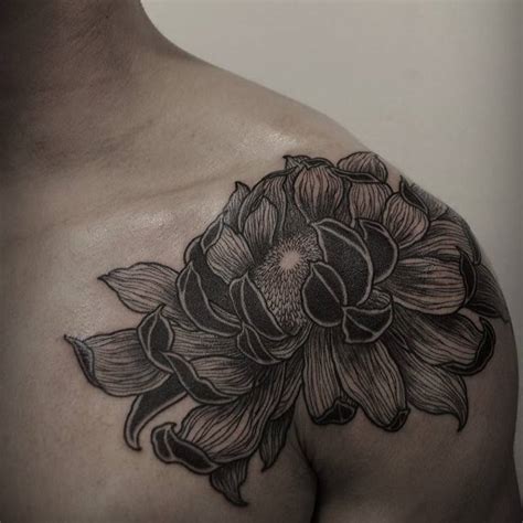 Chrysanthemum tattoo on the left shoulder.