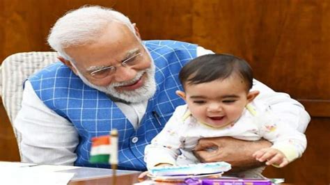 Photos of PM Narendra Modi playing with baby in Parliament go viral | India News | Zee News