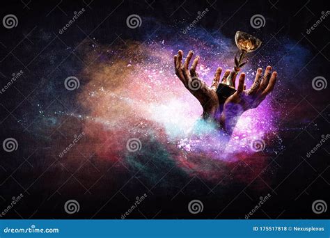 Hand Holding Up a Gold Trophy Cup Against Dark Background Stock Photo - Image of background ...