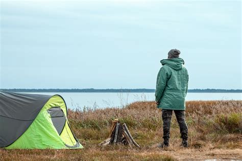 Premium Photo | A bearded man near a camping tent in green nature and the lake. travel, tourism ...