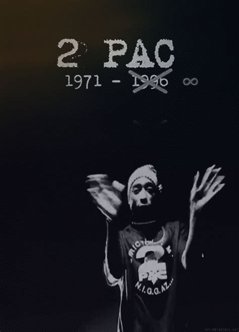 a man standing in front of a black background with the words 2pac written on it