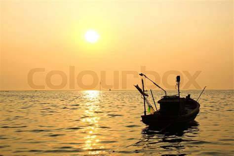 Silhouette of fishing boat at sunset | Stock image | Colourbox