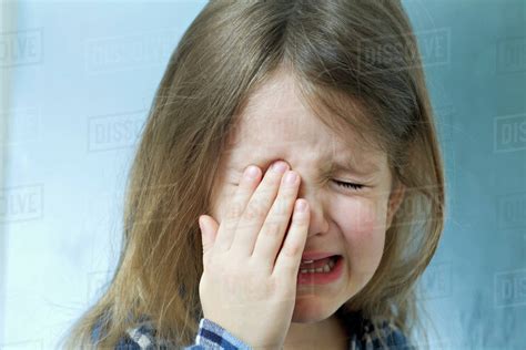 Close-up of a young girl crying - Stock Photo - Dissolve