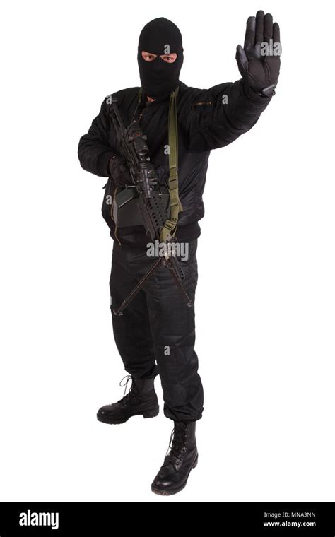 robber in black uniform and mask with machine gun Stock Photo - Alamy