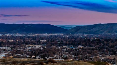 the city is surrounded by mountains and trees in the distance, as seen ...