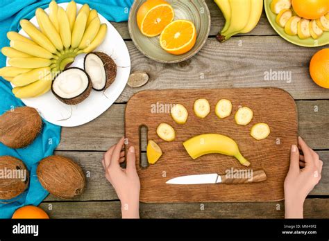 person slicing banana Stock Photo - Alamy