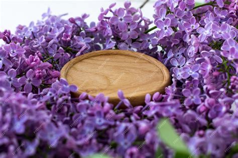 Premium Photo | Wooden stand surrounded by lilacs wooden round background