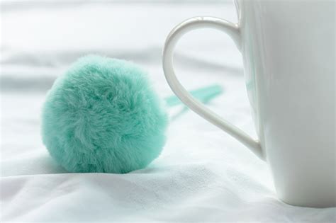 White Ceramic Coffee Drink Cup With Soft Fluffy Cute Green Pen On Fabric In Morning Light For ...