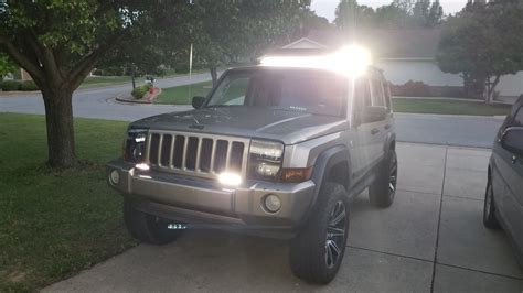 52" 700 watt curved led bar on 06' Jeep Commander, mounted on front of cross-bar of roof rack ...